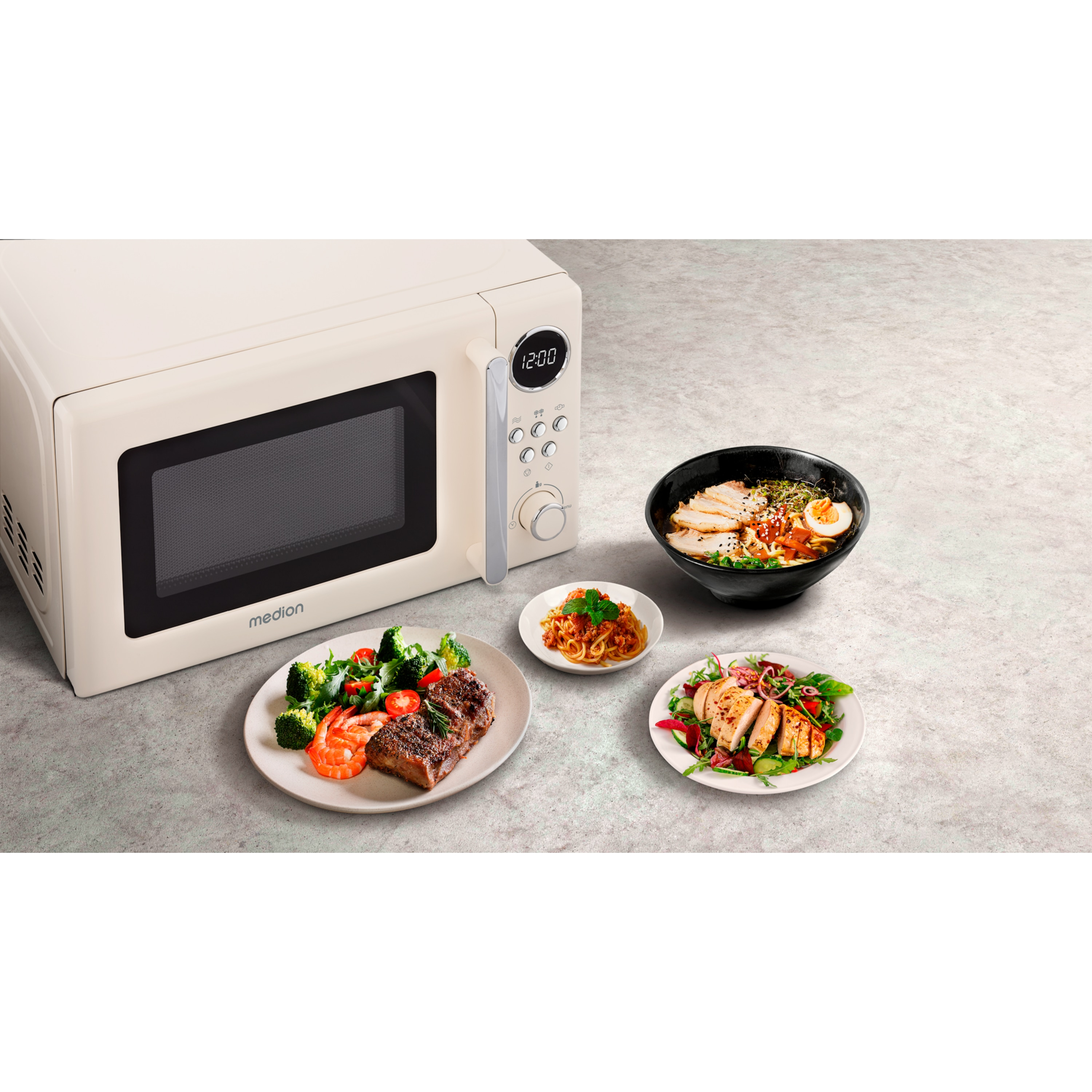 Kremowy microwave Medion z trzema daniami obok.