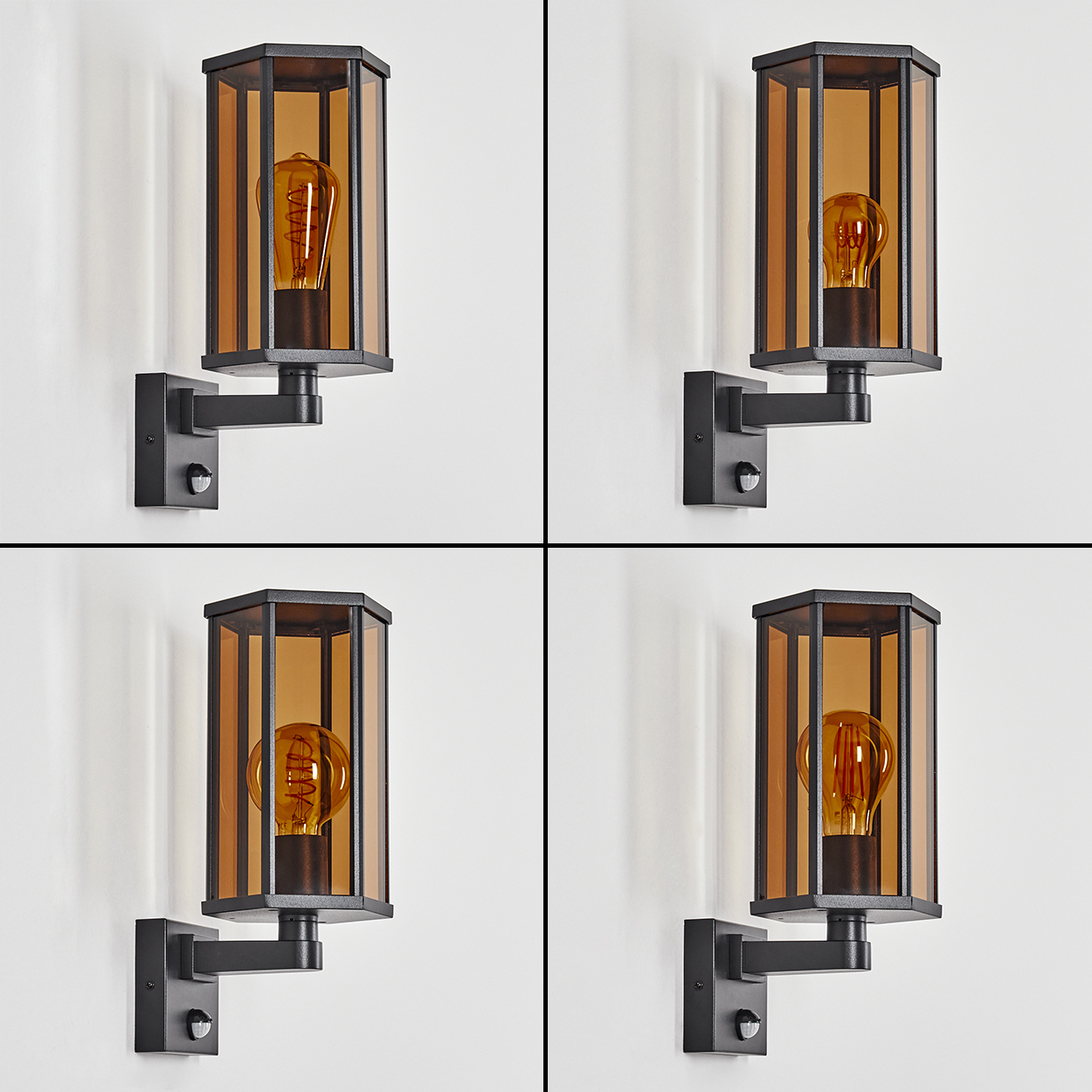 Eine schwarze Wandleuchte mit bernsteinfarbenem Glas und Glühbirne.
