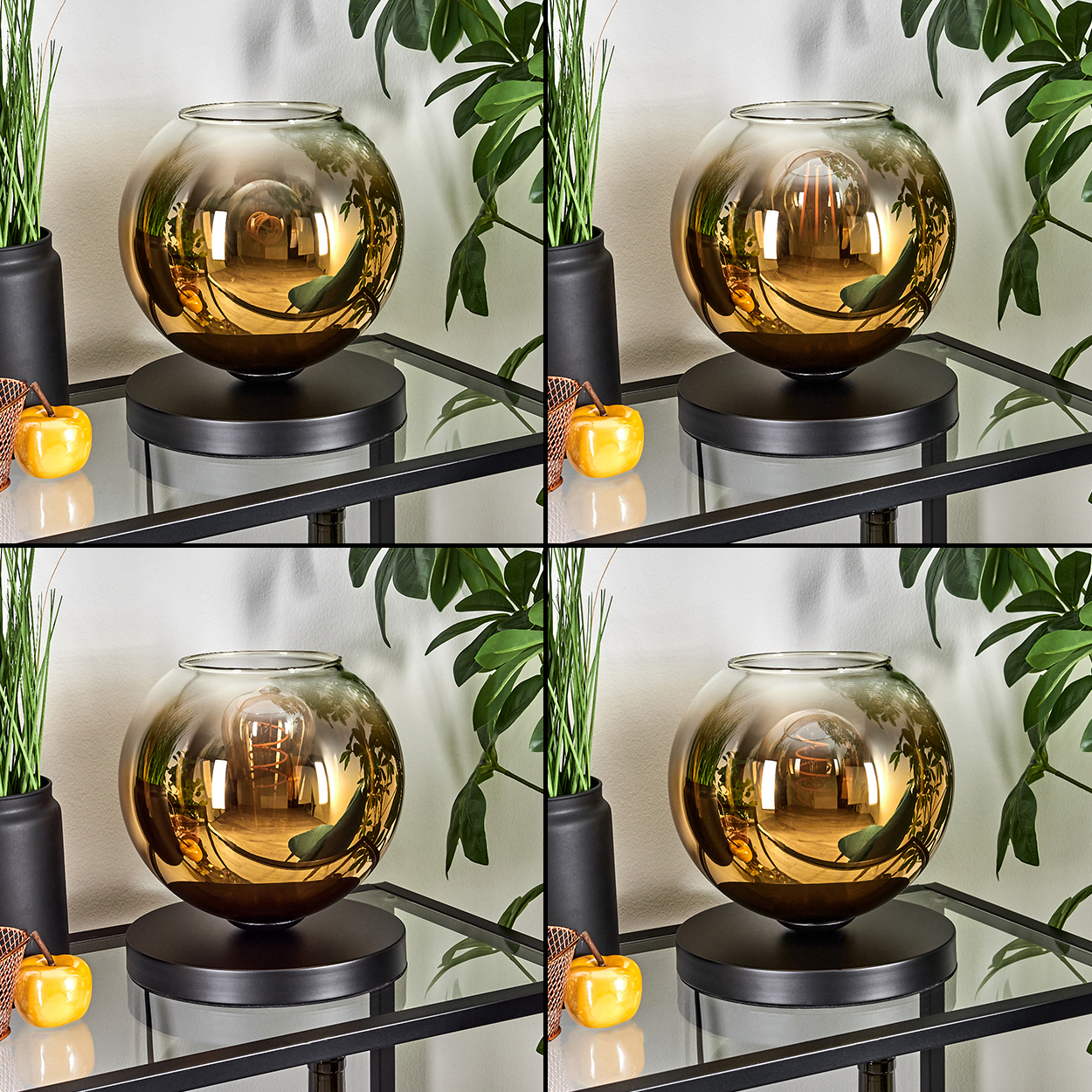 Goldene Glaskugel-Lampe auf schwarzem Sockel, neben Topfpflanzen und gelben Äpfeln.