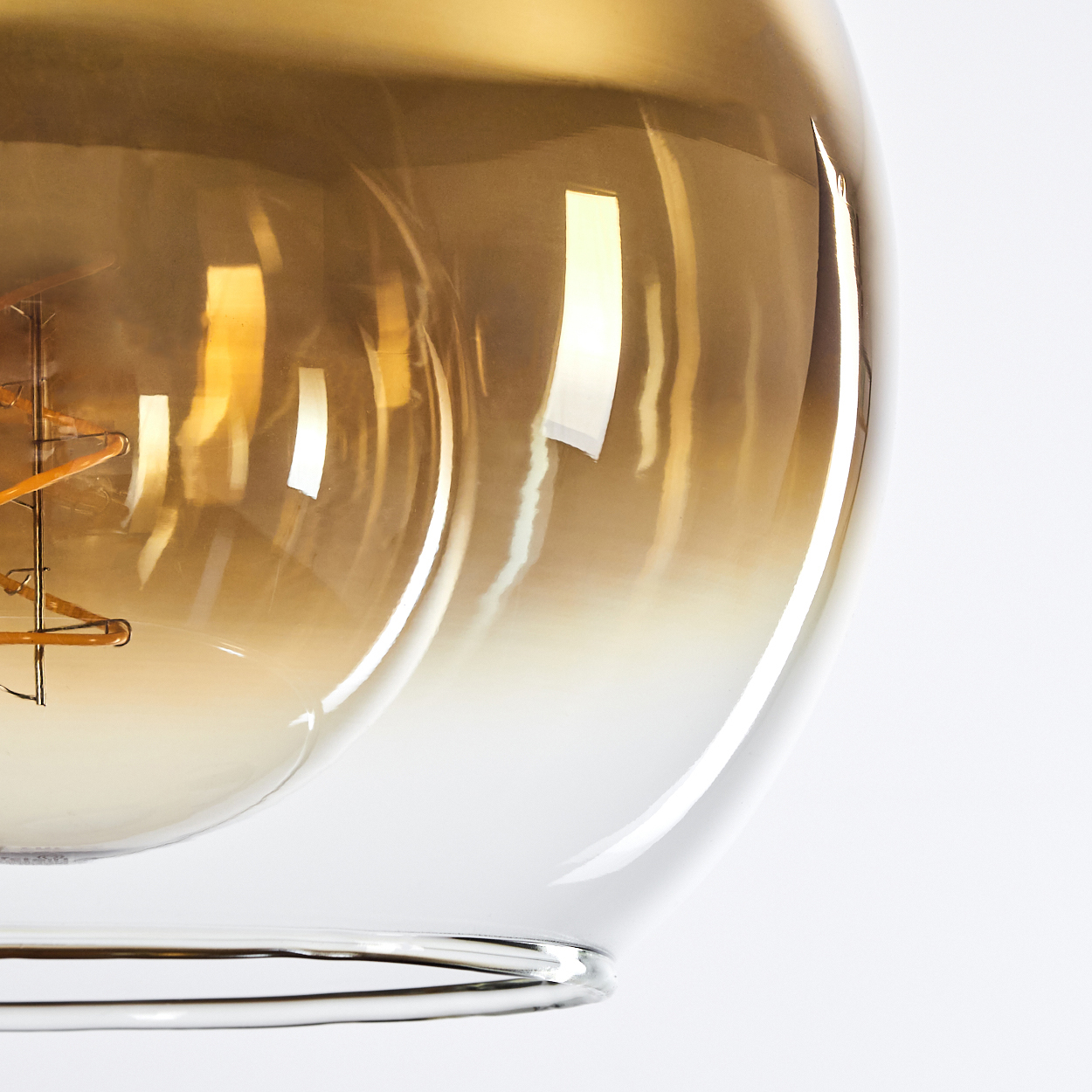 Nahaufnahme einer Glühbirne mit bernsteinfarbenem Glas und Glühfaden.