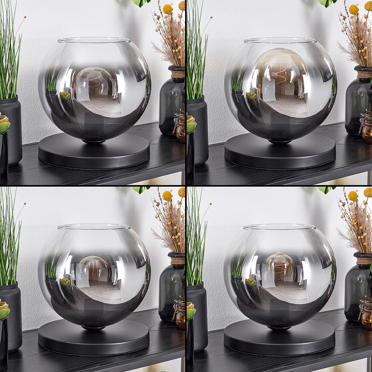 Eine Glaskugel-Lampe mit Glühbirne auf einem schwarzen Regal mit Pflanzen.