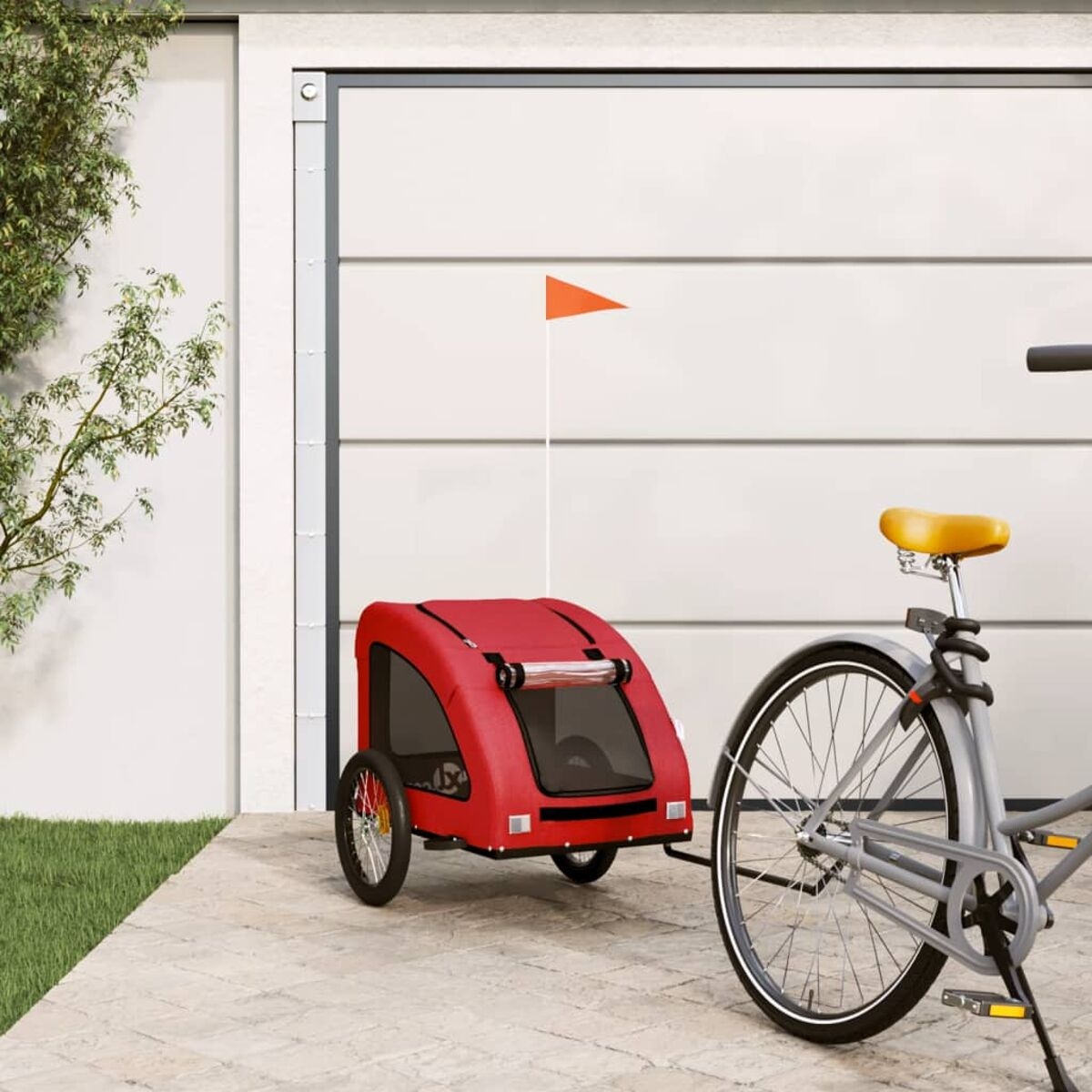 Ein roter Fahrradanhänger mit orangefarbener Flagge steht neben einem Fahrrad.