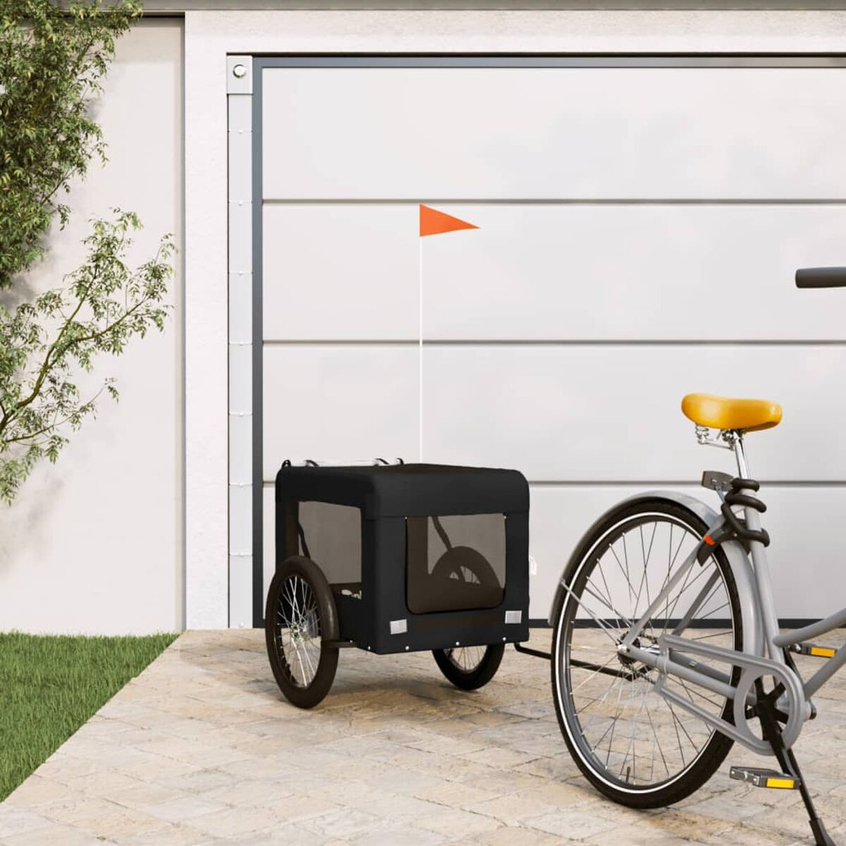 Ein Fahrrad mit Anhänger steht vor einem Garagentor. Ein orangeroter Fähnchen weht.