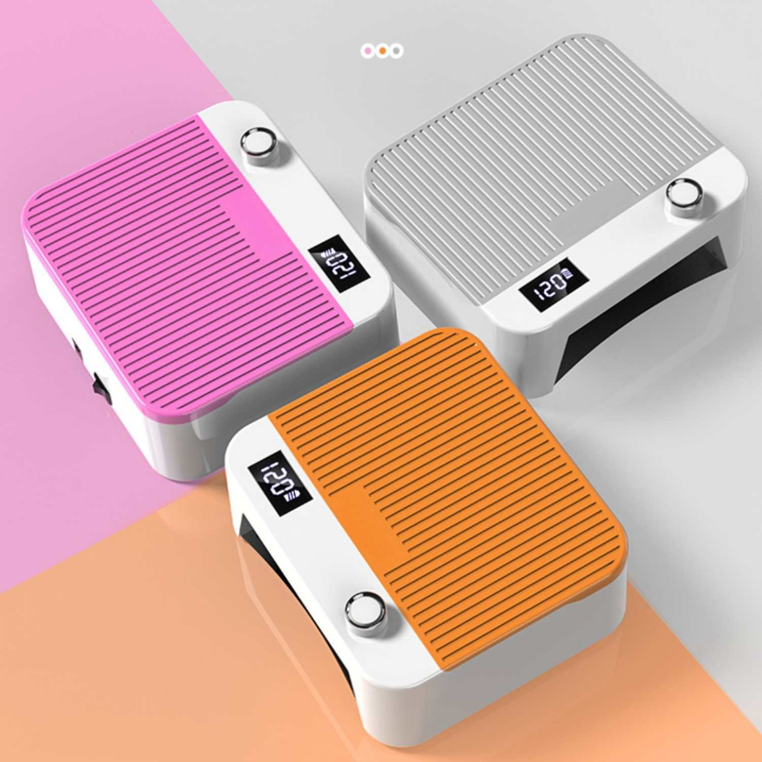 Drei Nageltrockner in Pink, Grau und Orange mit digitalen Anzeigen.