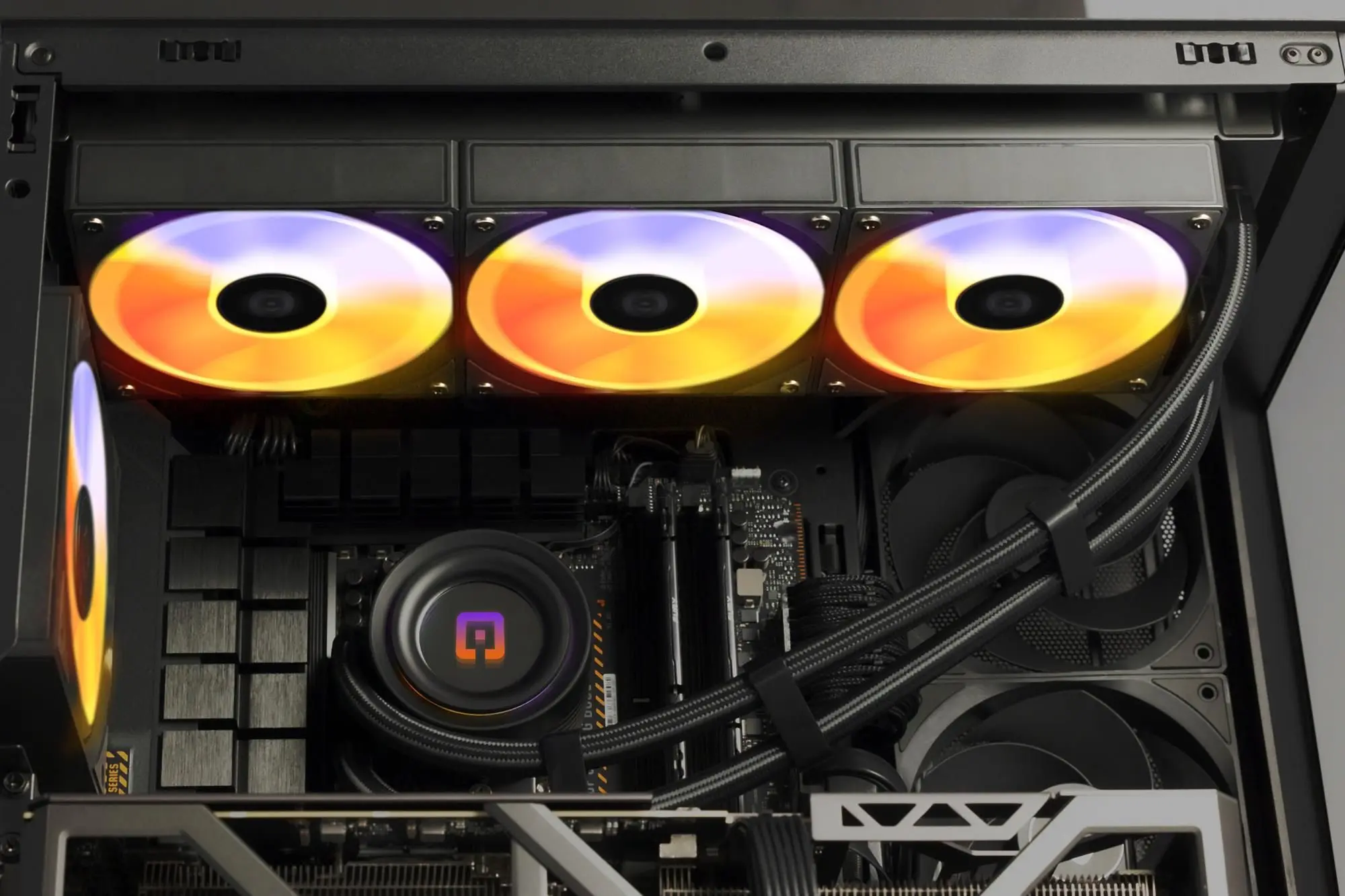 Ein Computergehäuse mit RGB-Lüftern, CPU-Kühler und Kabeln.