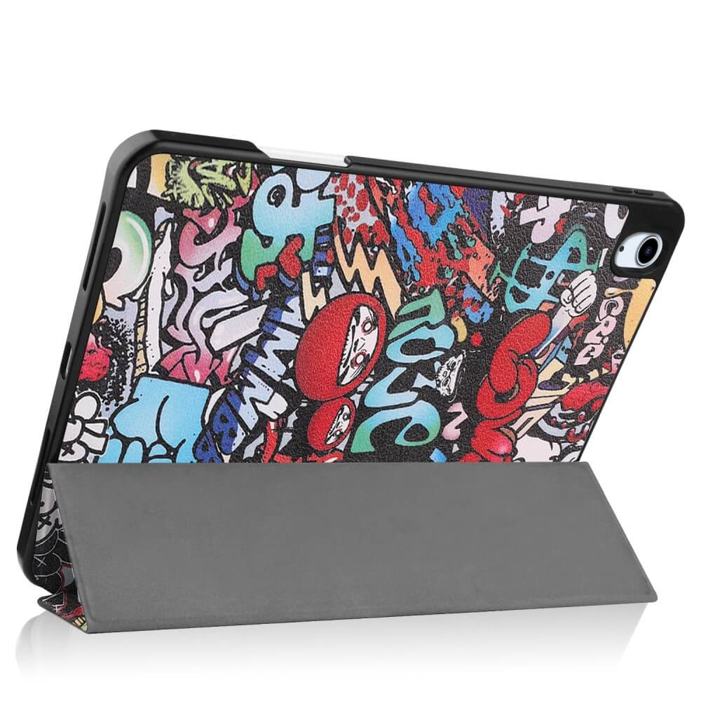 Une tablette avec un motif graffiti coloré et un support gris.