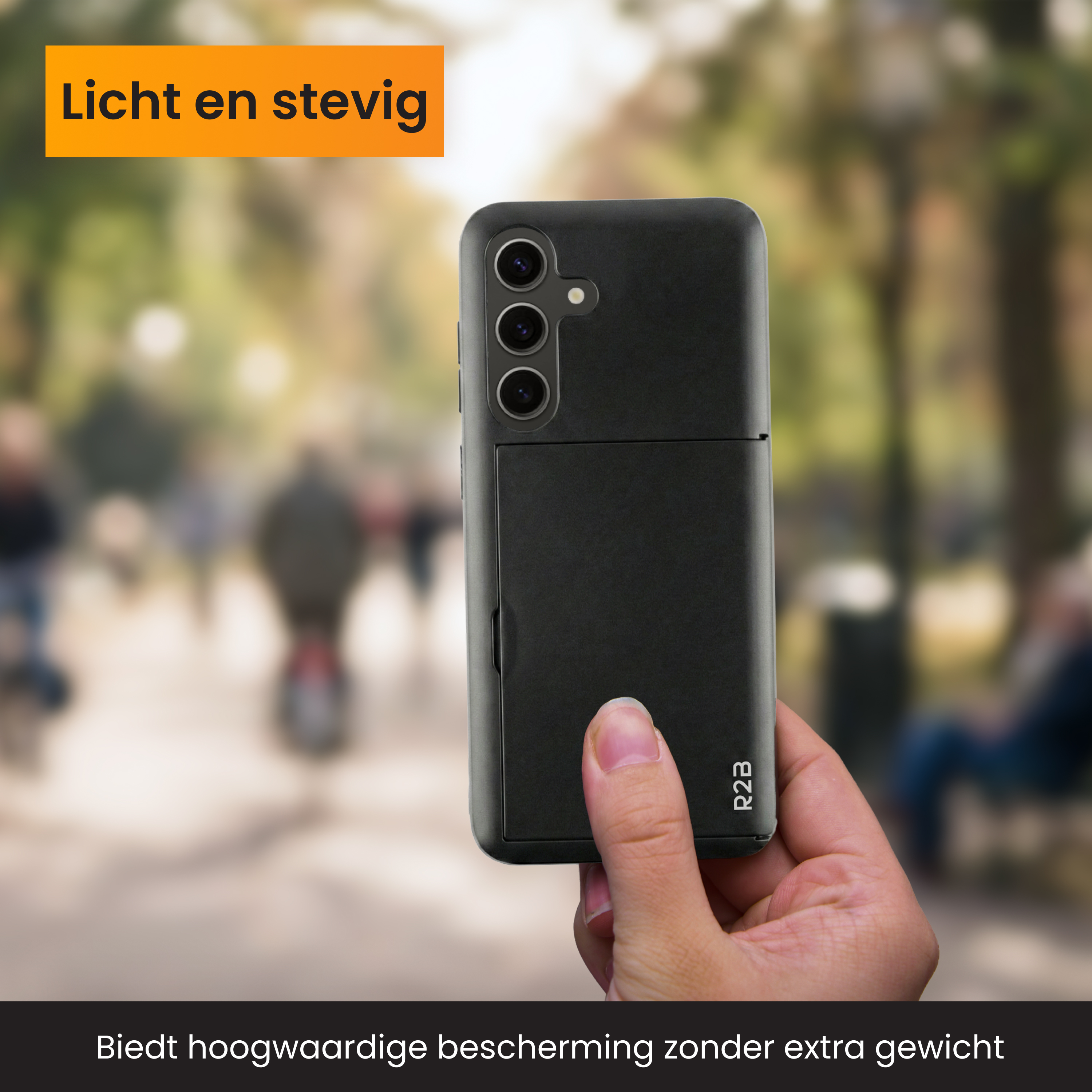 Zwarte telefoon met drie camera's, vastgehouden door een hand. Buiten.