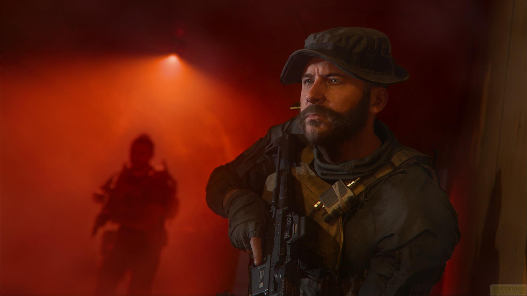 Ein Soldat mit Hut und Bart blickt nach rechts. Rotes Licht beleuchtet die Szene.