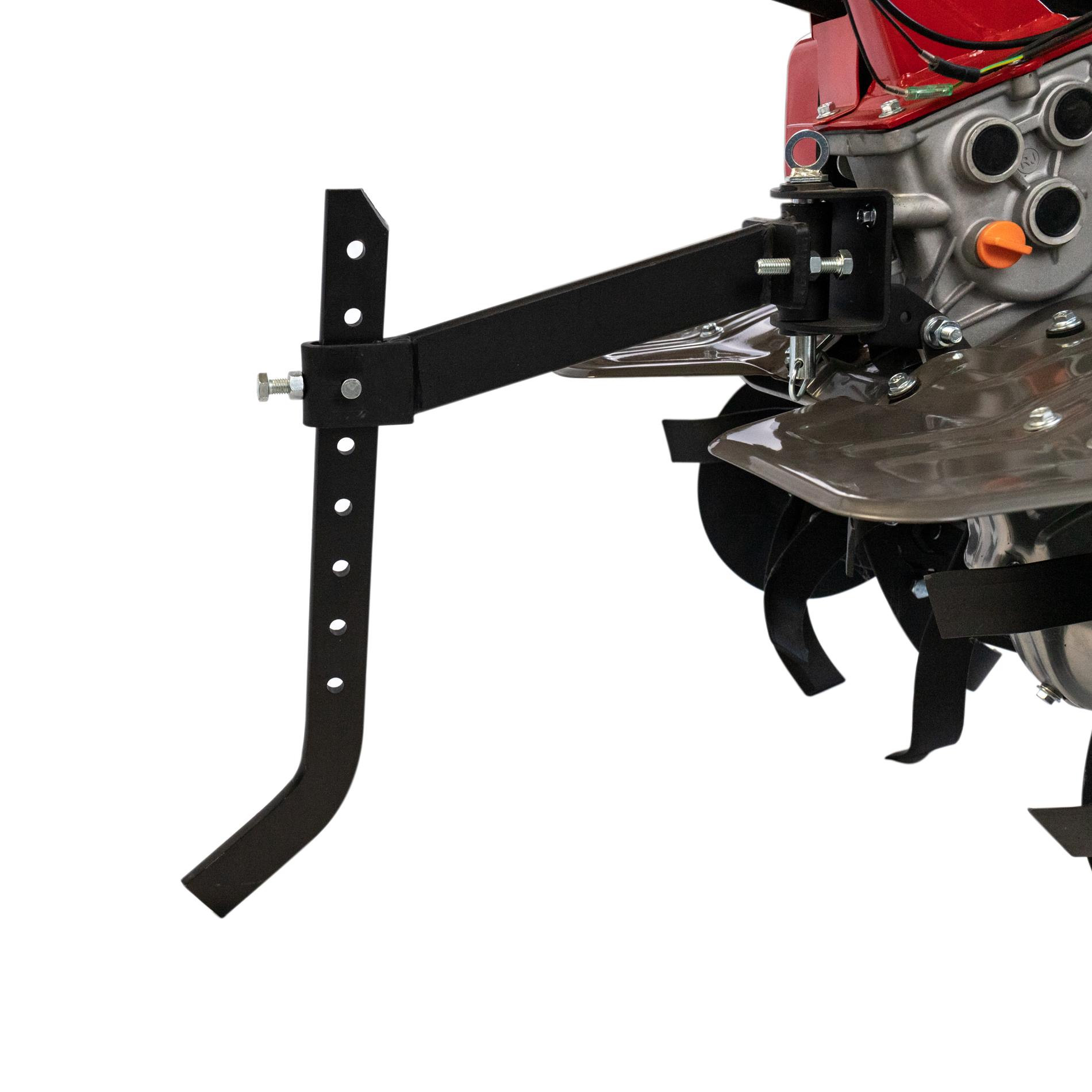 Zbliżenie czerwonego glebogryzarki z czarnymi metalowymi częściami i obrotowymi ostrzami.