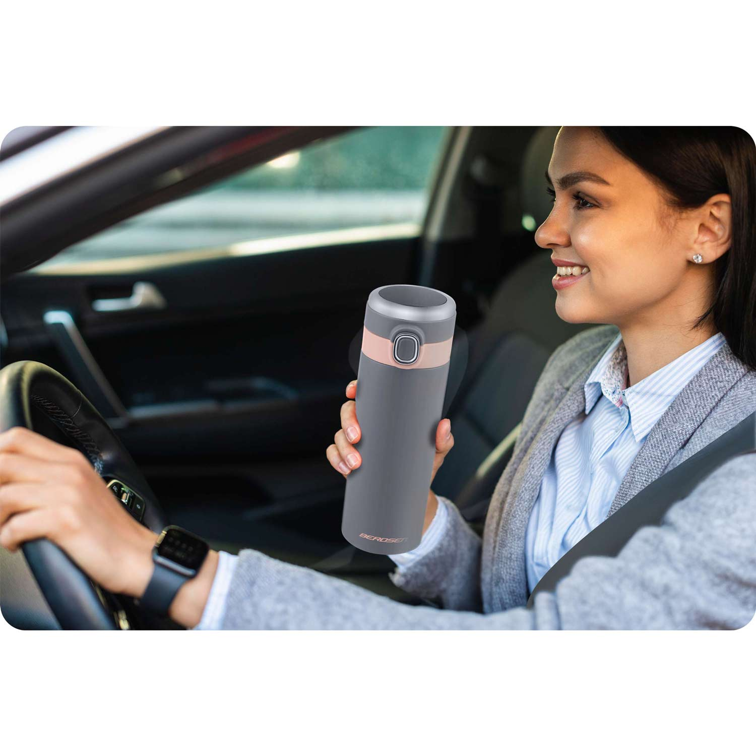 Kobieta w samochodzie trzyma szary termos z różowym akcentem.