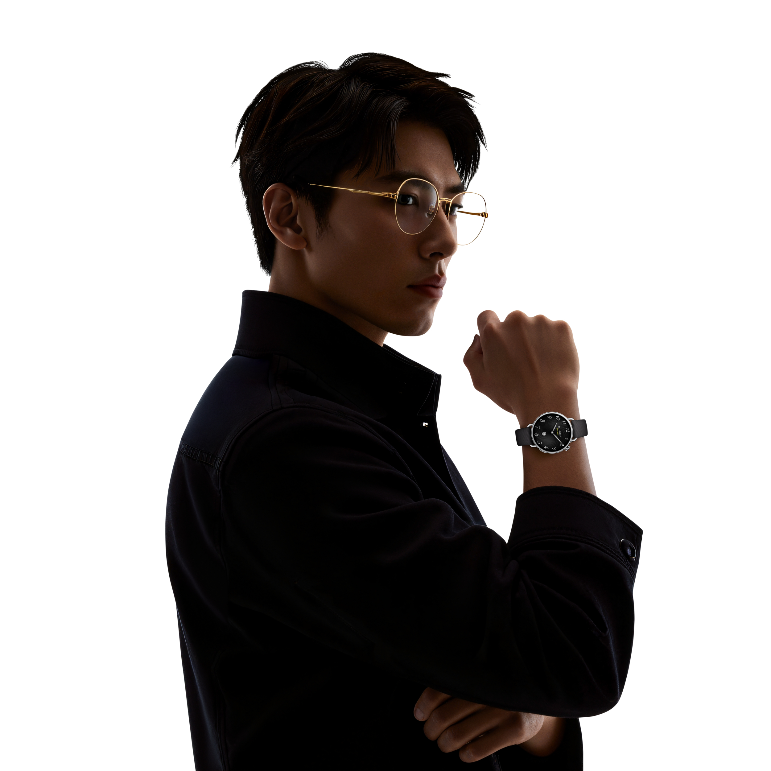 A man wearing glasses, a black shirt, and a watch on his wrist.
