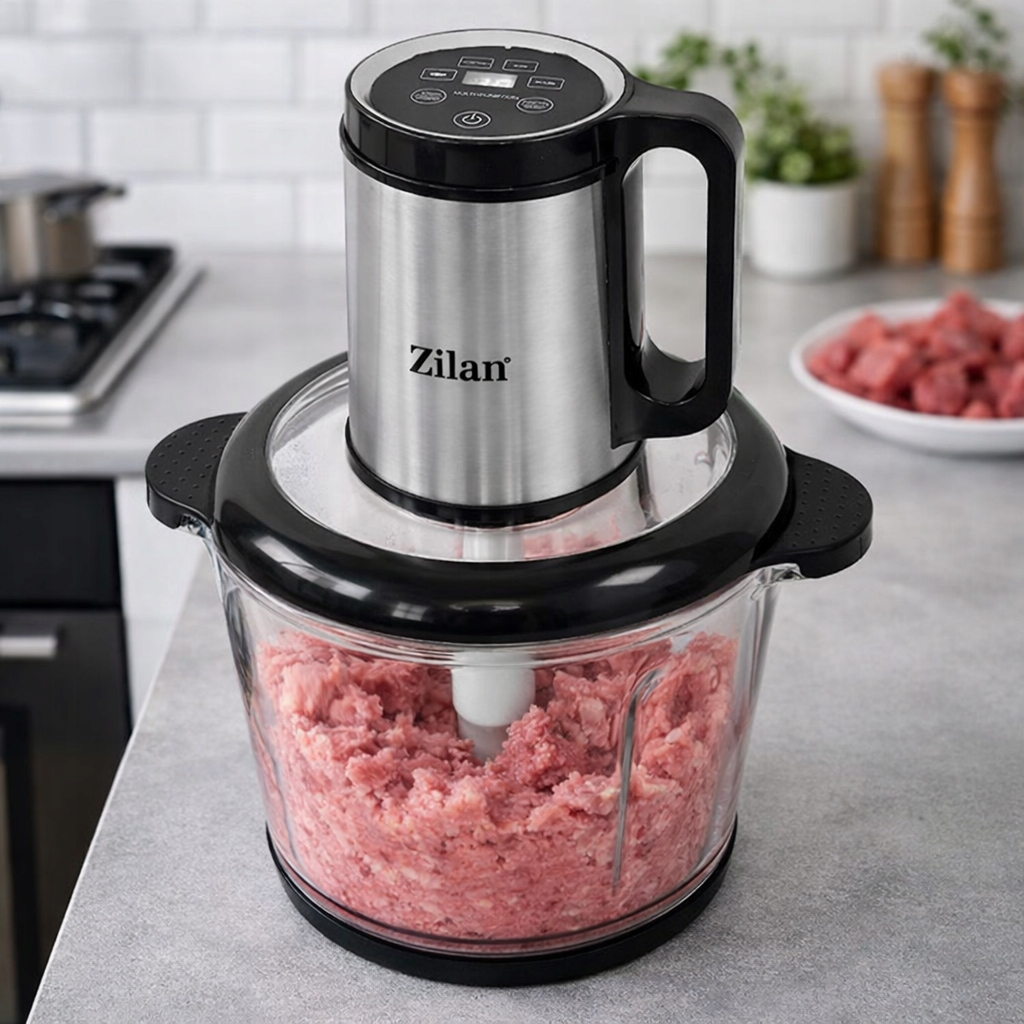 Robot kuchenny Zilan ze srebrną obudową i czarnym uchwytem stoi na blacie obok mielonego mięsa.