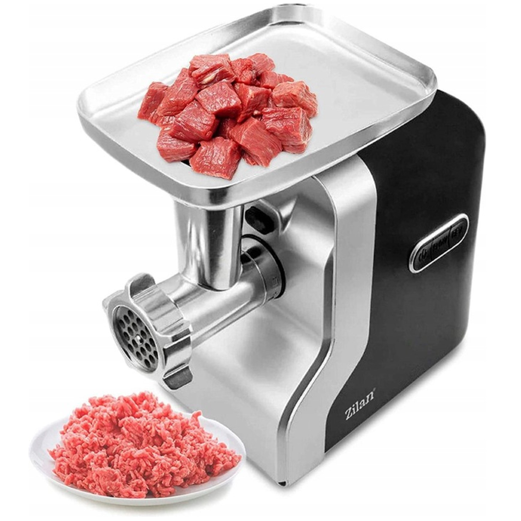 Srebrno-czarna maszynka do mielenia mięsa z surowym mięsem w kostkach na górze i mielonym mięsem poniżej.