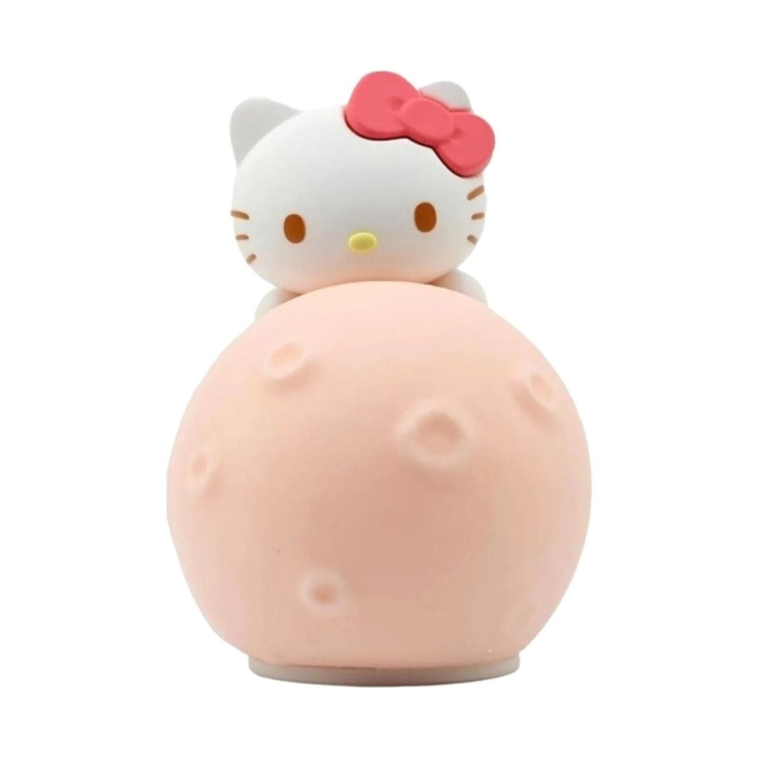 Hello Kitty con fiocco rosso siede su una palla rosa con crateri.