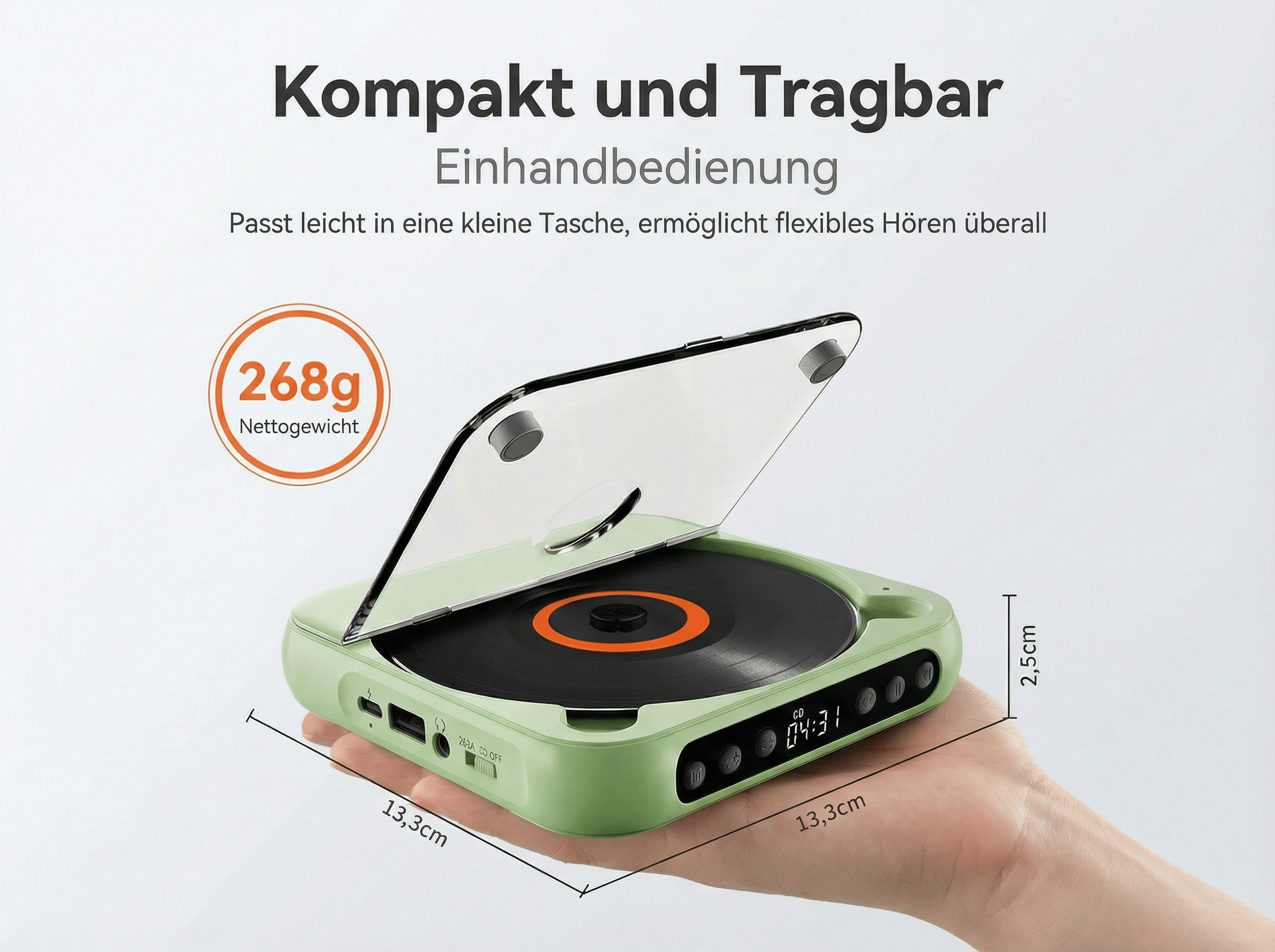 Ein grüner tragbarer Plattenspieler mit offenem Deckel, gehalten in einer Hand.