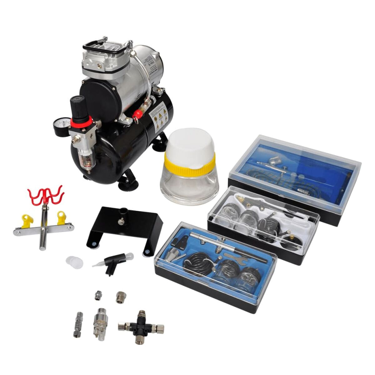 Un compressore con accessori: aerografo, contenitori, tubi e supporto.