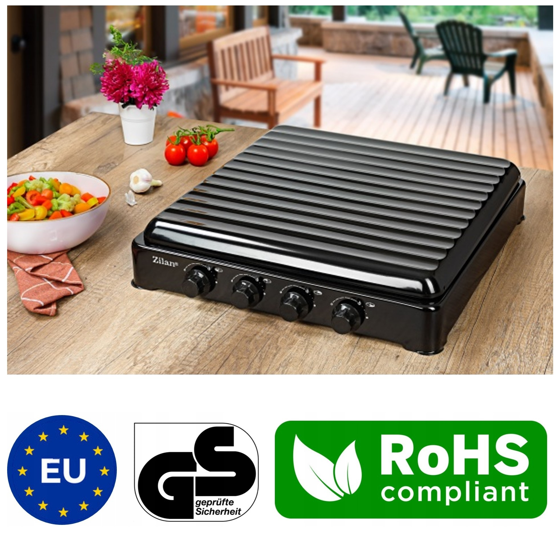 Czarny grill kontaktowy stoi na drewnianym stole z warzywami i kwiatami.