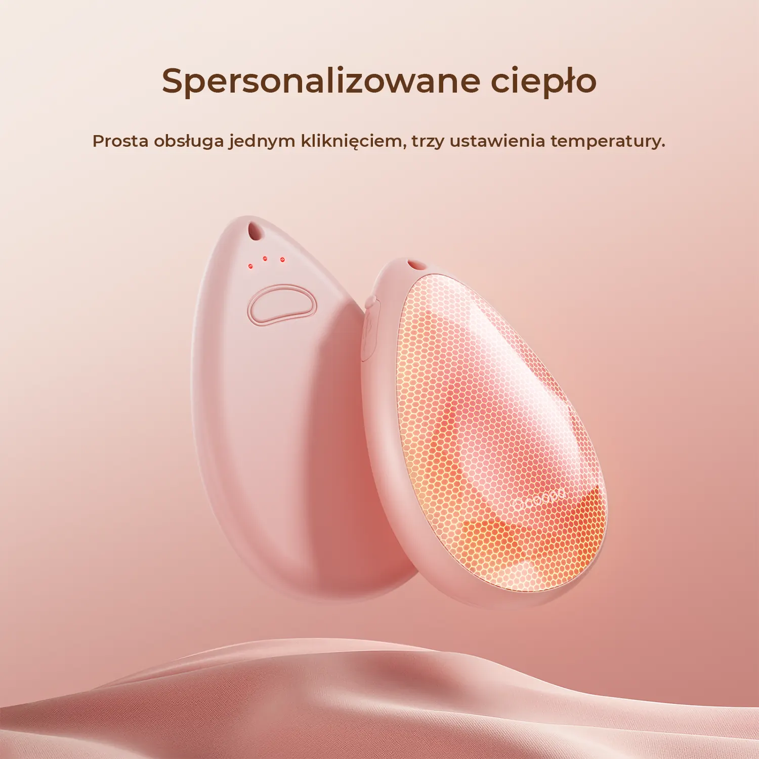 Dwa różowe podgrzewacze do rąk z wzorem plastra miodu.