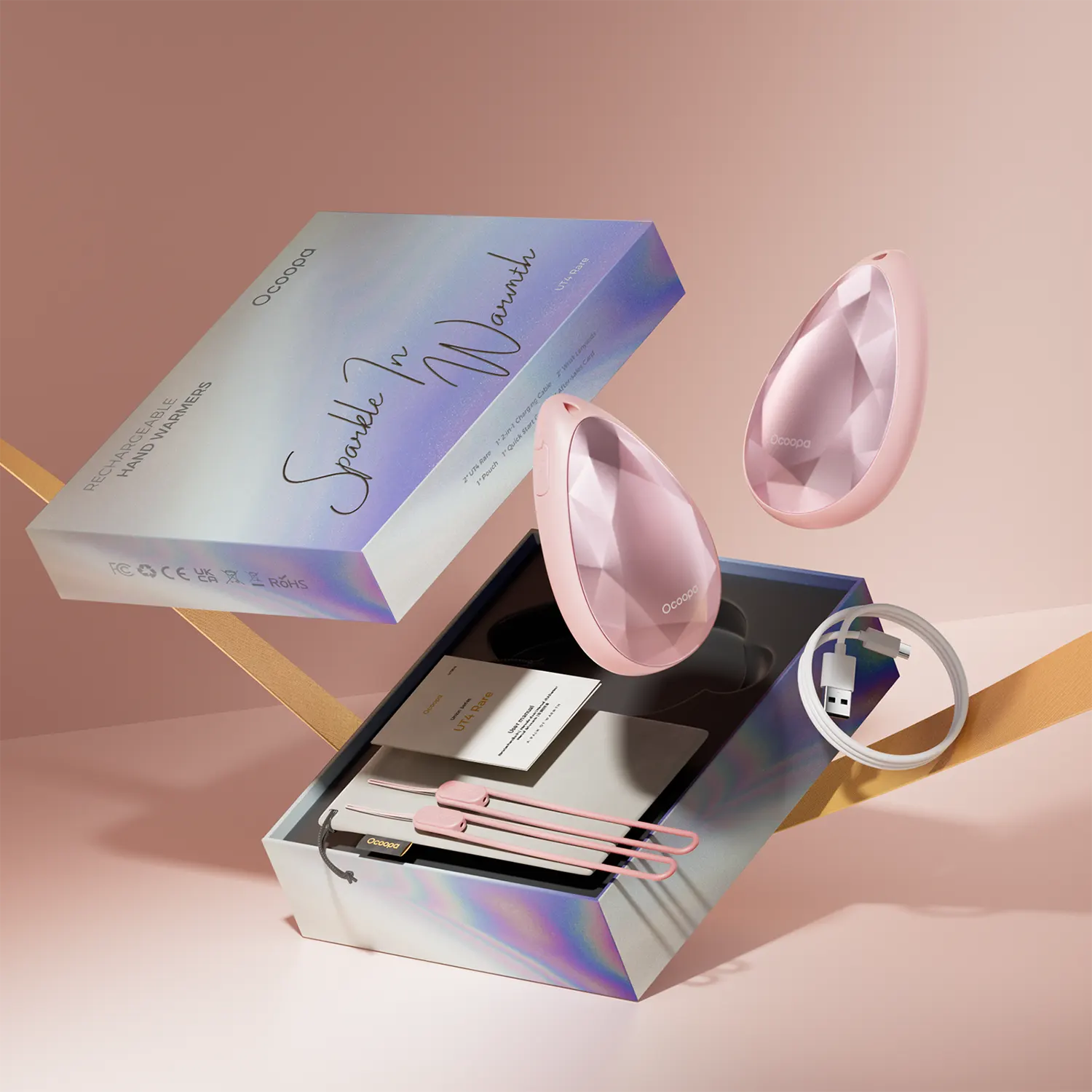 Różowe podgrzewacze do rąk w kształcie serca z akcesoriami w otwartym pudełku.