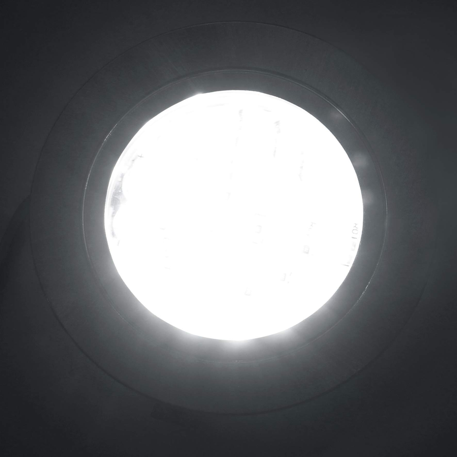 Ein heller, runder Lichtstrahl scheint von oben in einen dunklen Raum.