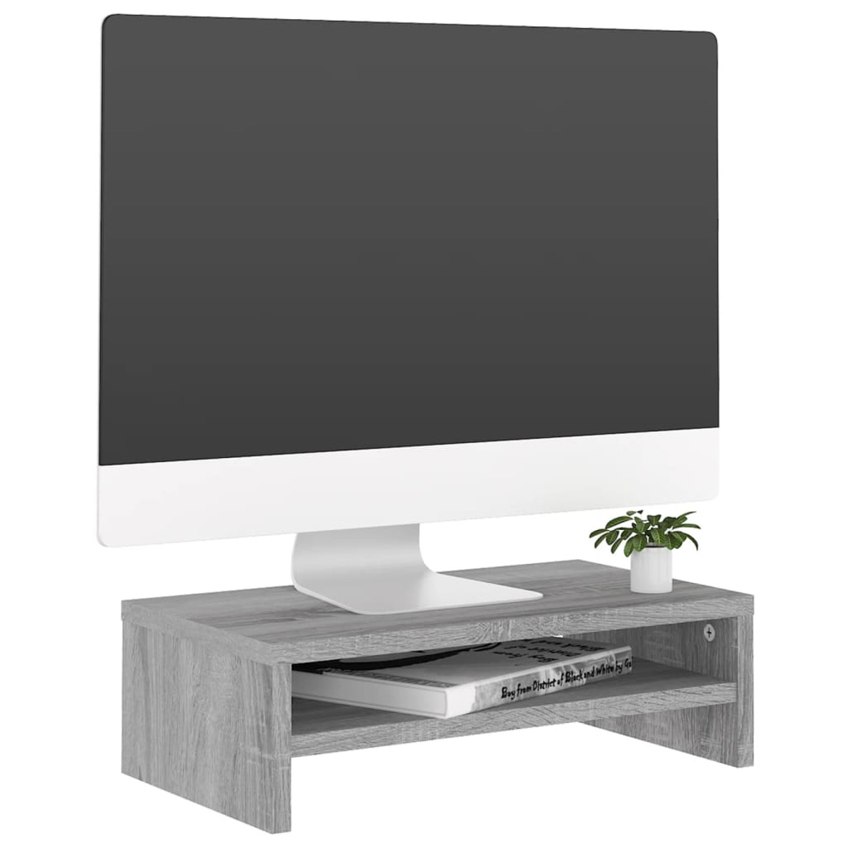 Un monitor se asienta sobre un estante de madera con un libro y una planta.
