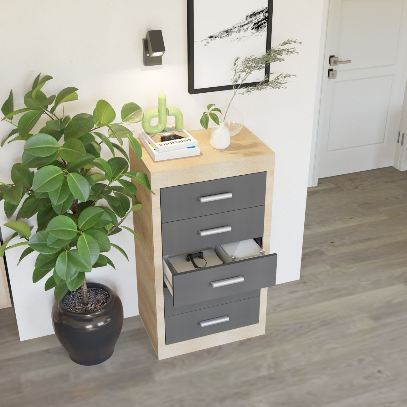 Un mueble auxiliar con cajones junto a una planta y un cuadro.