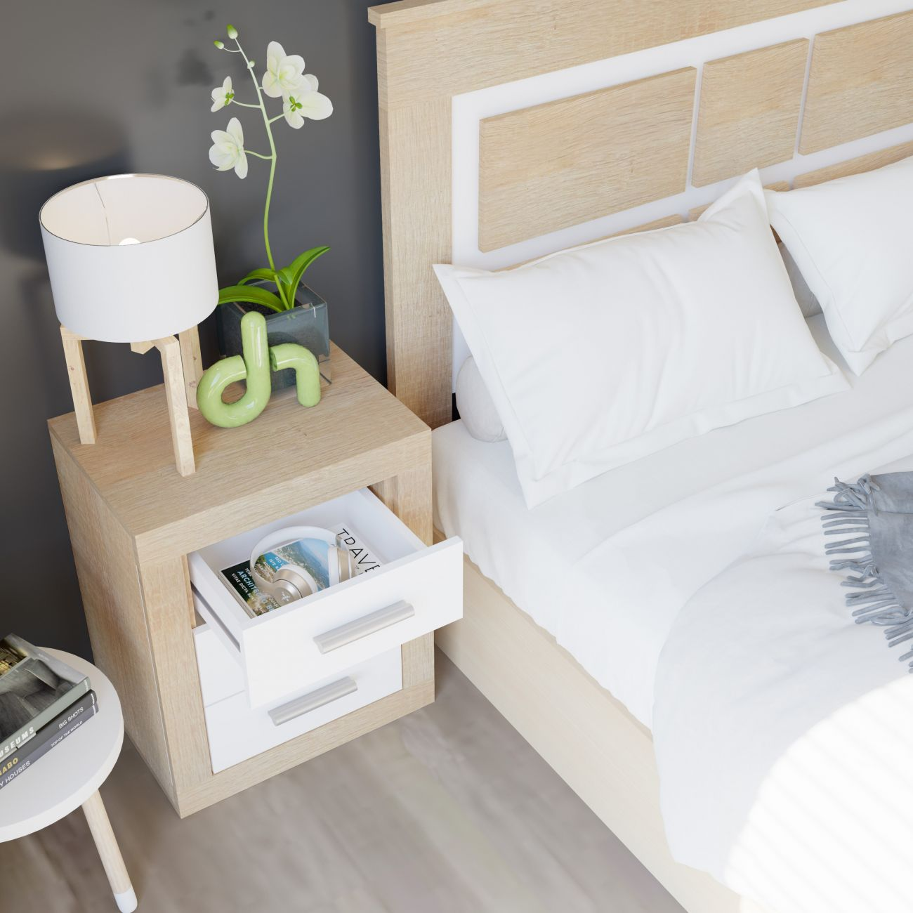 Una mesita de noche con lámpara, orquídea y cajón abierto junto a una cama blanca.