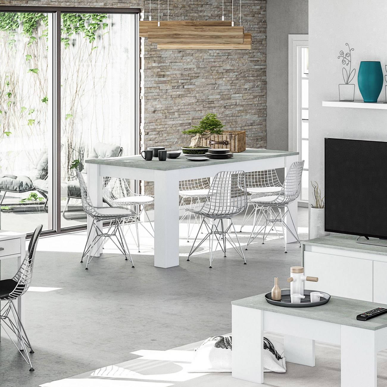 Comedor moderno con muebles blancos, sillas de alambre y pared de piedra.