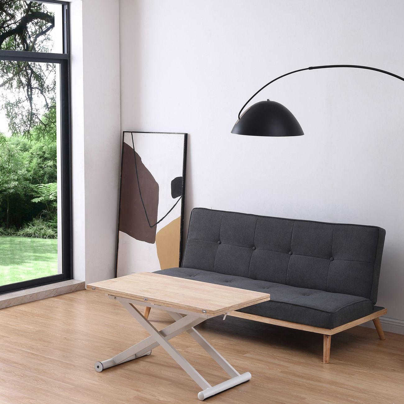 Una sala de estar con sofá, mesa de centro, lámpara y un cuadro.