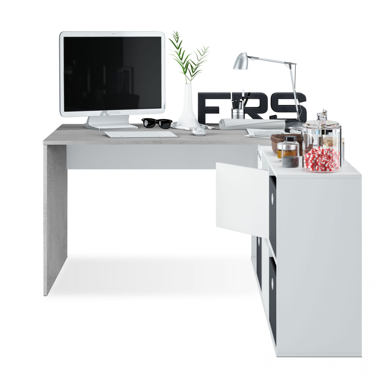 Un escritorio con monitor, teclado, lámpara, jarrón y decoraciones.