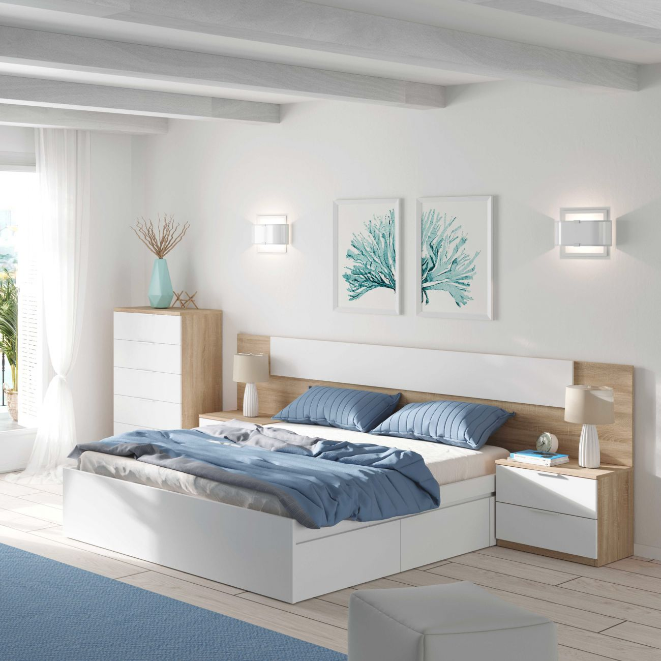 Un dormitorio con cama blanca, almohadas y mantas azules.