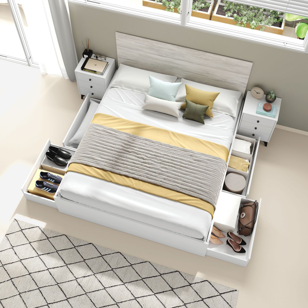 Un dormitorio con cama con cajones, mesitas de noche y ventana.