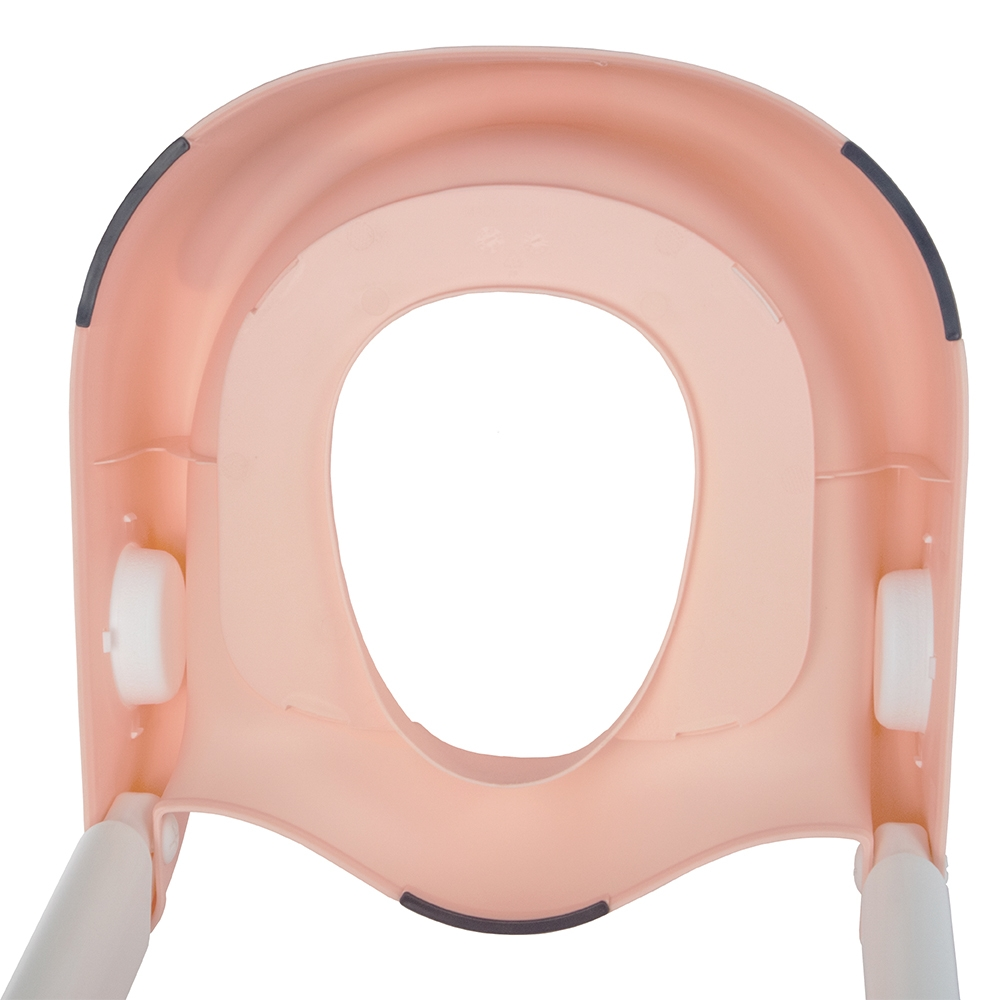 Asiento de inodoro infantil rosa con asas blancas y recorte ovalado.