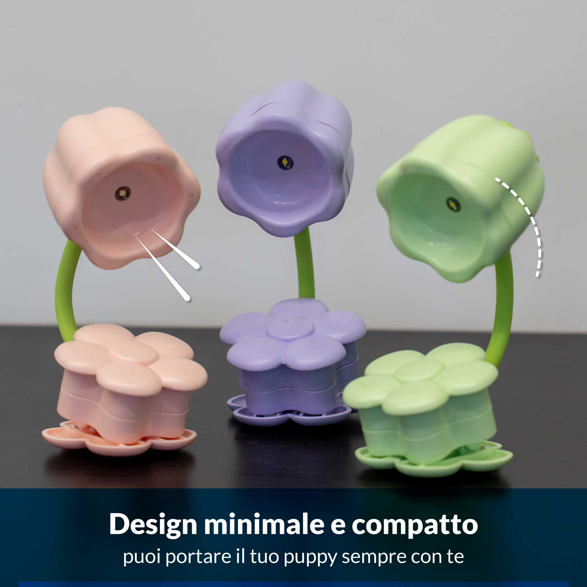 Tre lampade a forma di fiore rosa, viola e verdi su un tavolo.