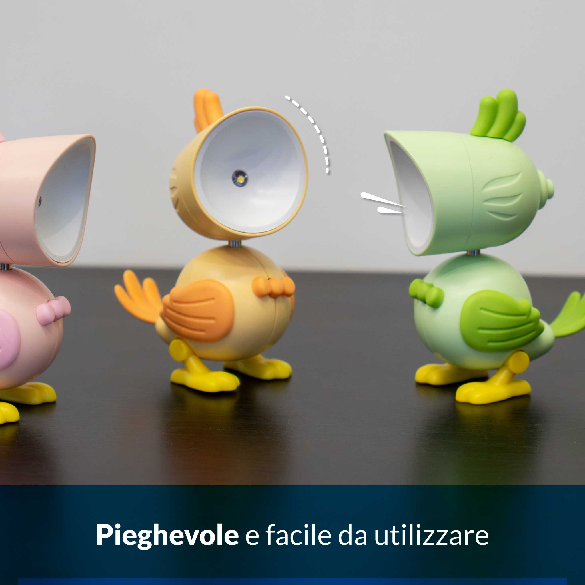Tre lampade a forma di uccello colorate: rosa, giallo e verde. Stanno una accanto all'altra.