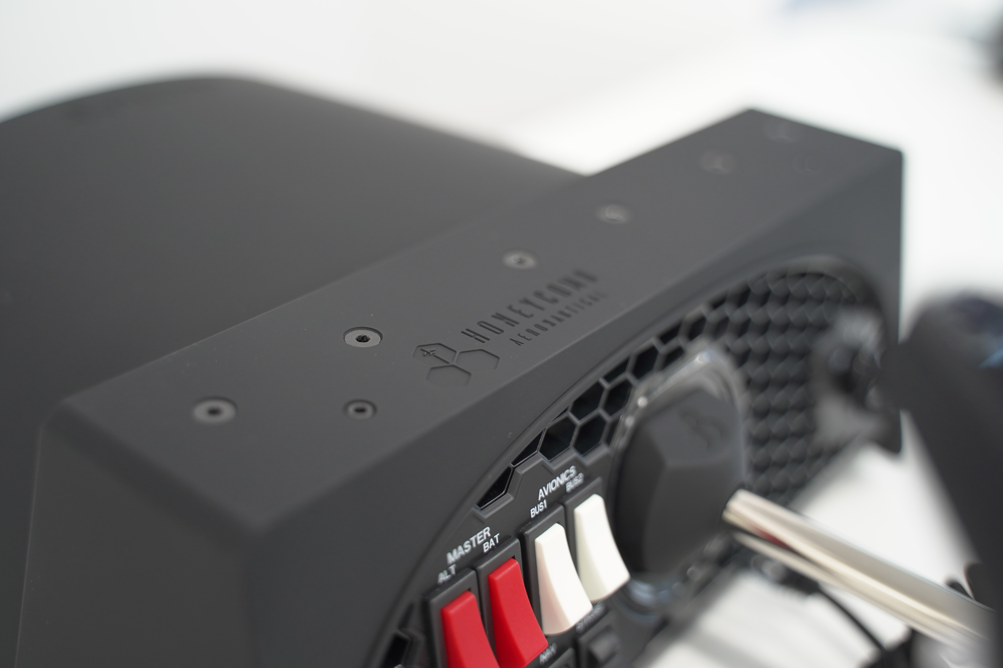 Close-up of a black flight control panel with red and white switches.