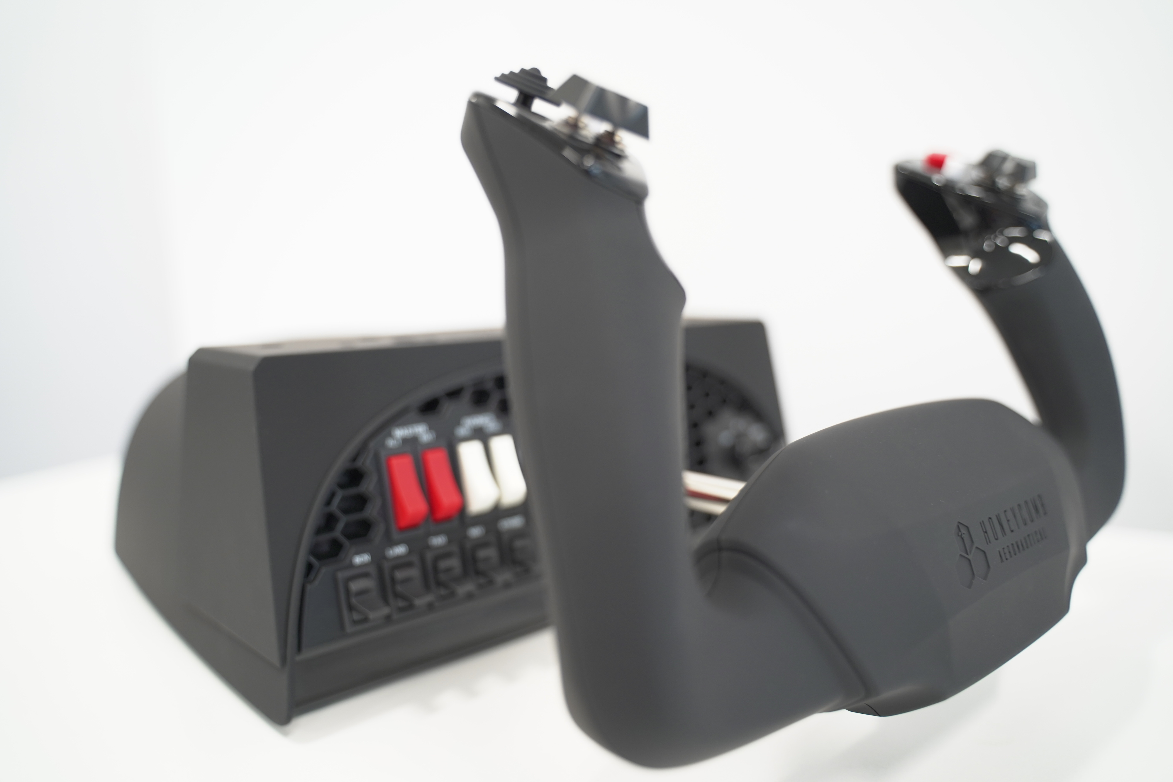 A black flight simulator yoke with controls and a control panel.