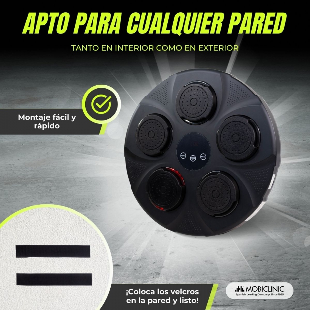 Un dispositivo circular negro con cinco almohadillas negras y una pantalla central, sobre un fondo gris texturizado.