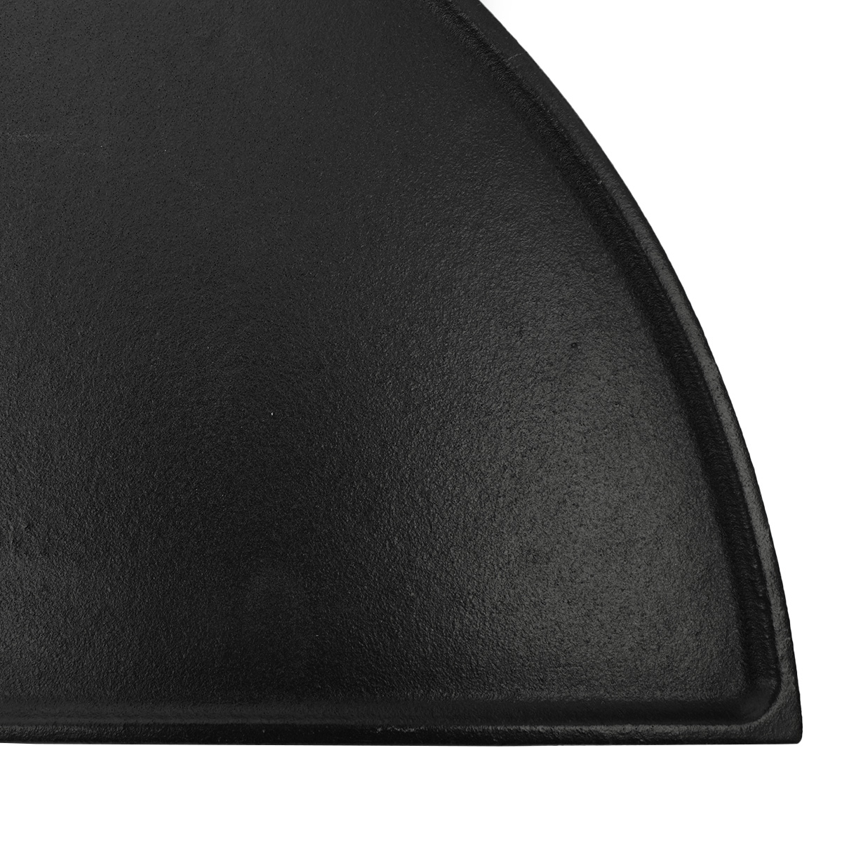 Close-up of a black cast iron pan with a curved edge.