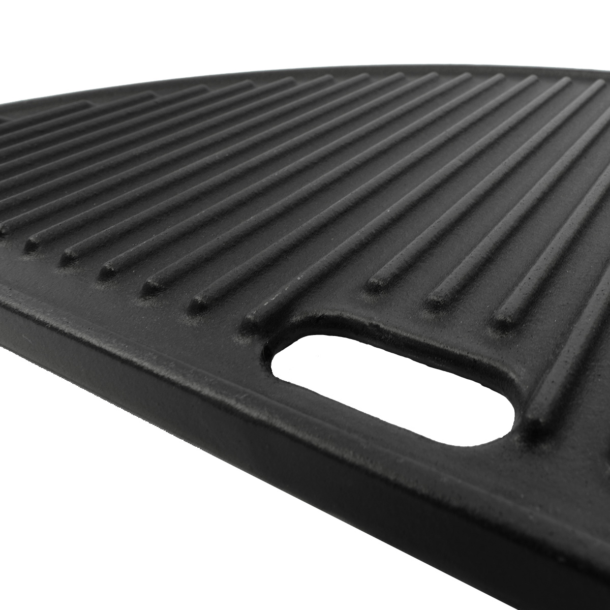 A black cast iron grill plate with ridges and a handle hole, isolated on white.
