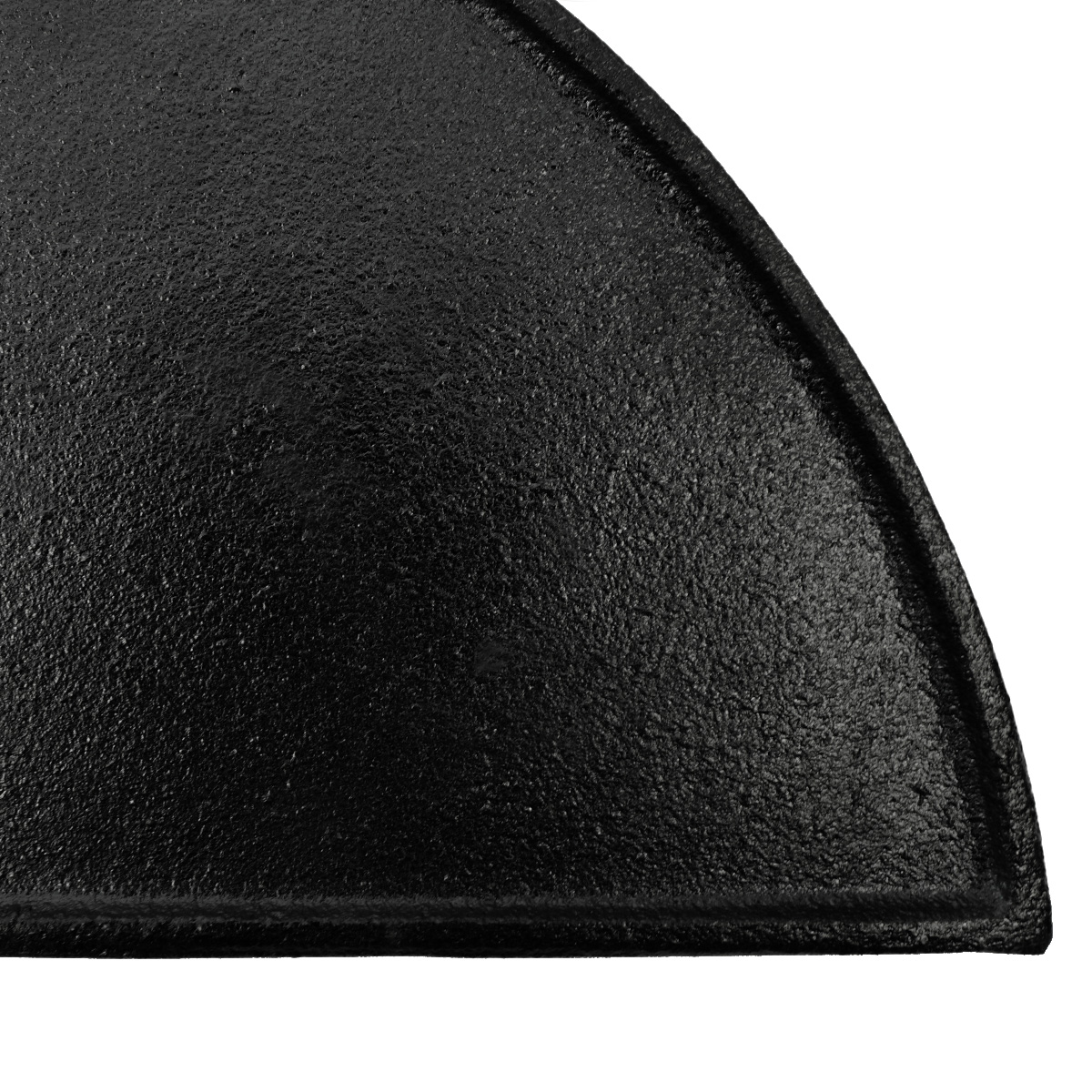 A black, textured cast iron wedge on a white background.