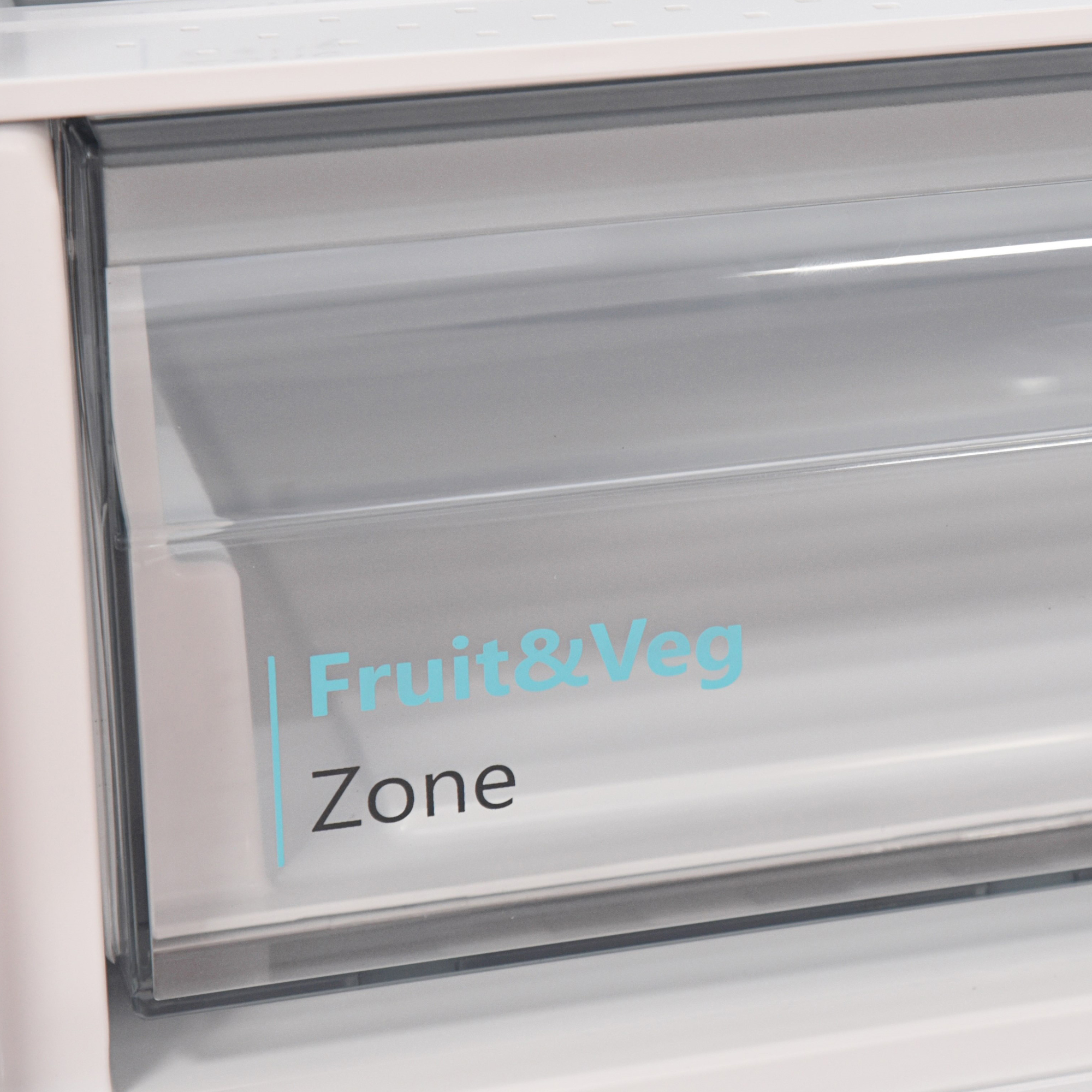 Ein transparenter Kühlschublade mit blauen Schriftzug "Fruit & Veg Zone".