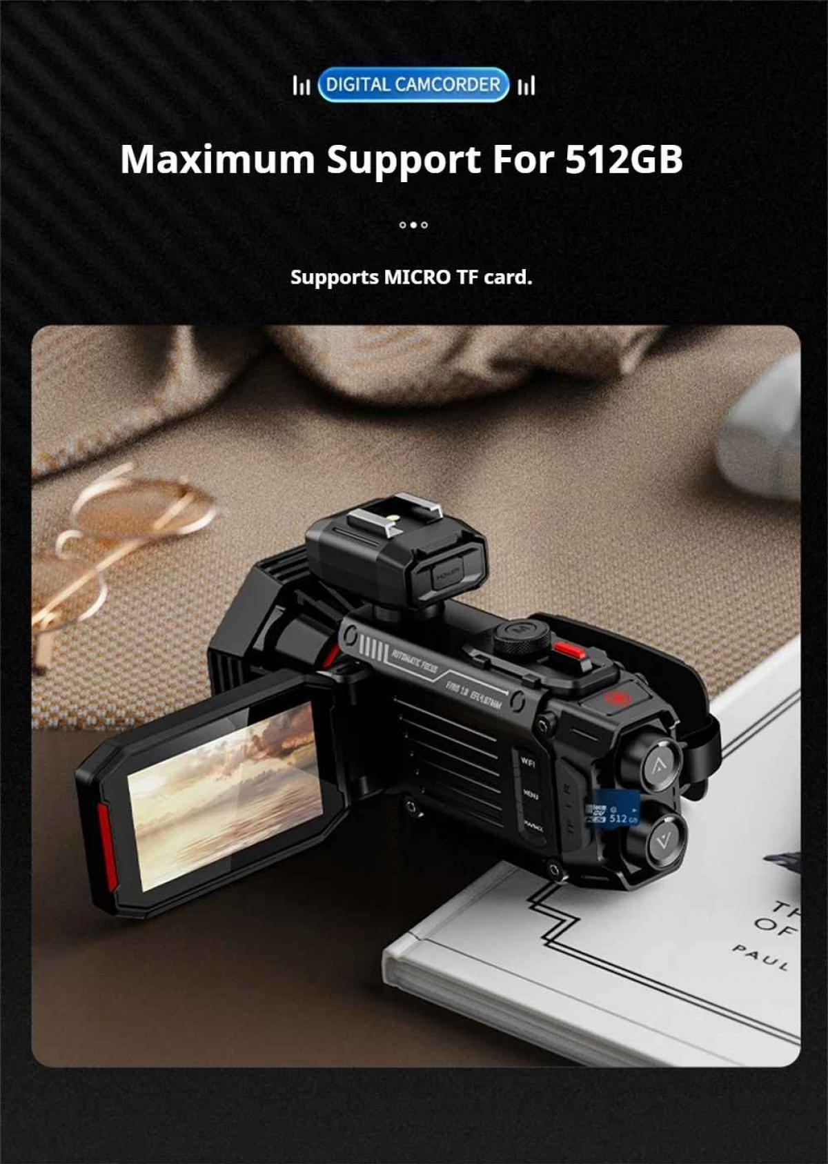 Schwarzer Camcorder mit geöffnetem Bildschirm, auf einem Buch liegend.
