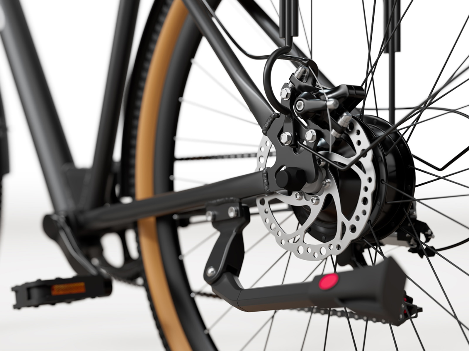 Zbliżenie tylnego koła czarnego roweru z brązową oponą.