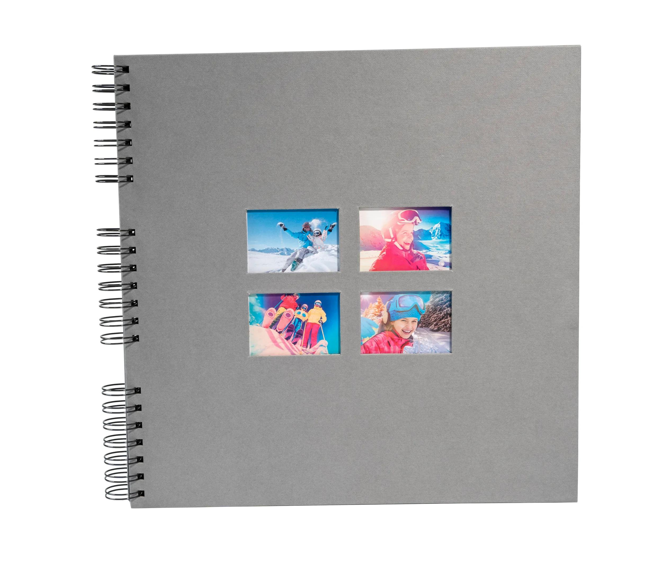 Álbum gris con cuatro fotos de esquí: snowboarder, niña sonriente, esquiadores, niña sonriente.