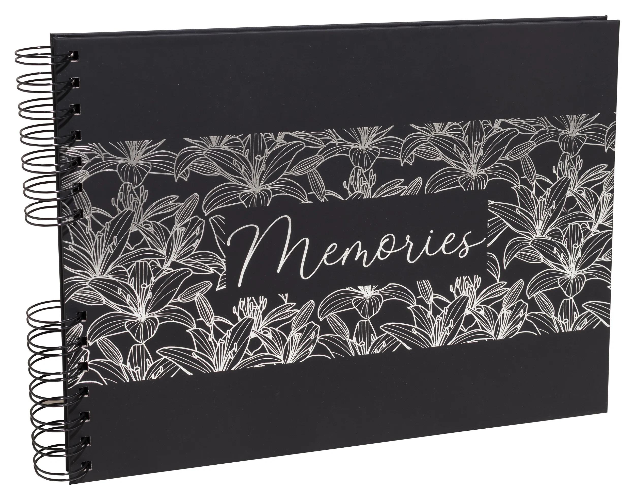 Álbum de recortes negro con diseño floral plateado y la palabra "Memories".