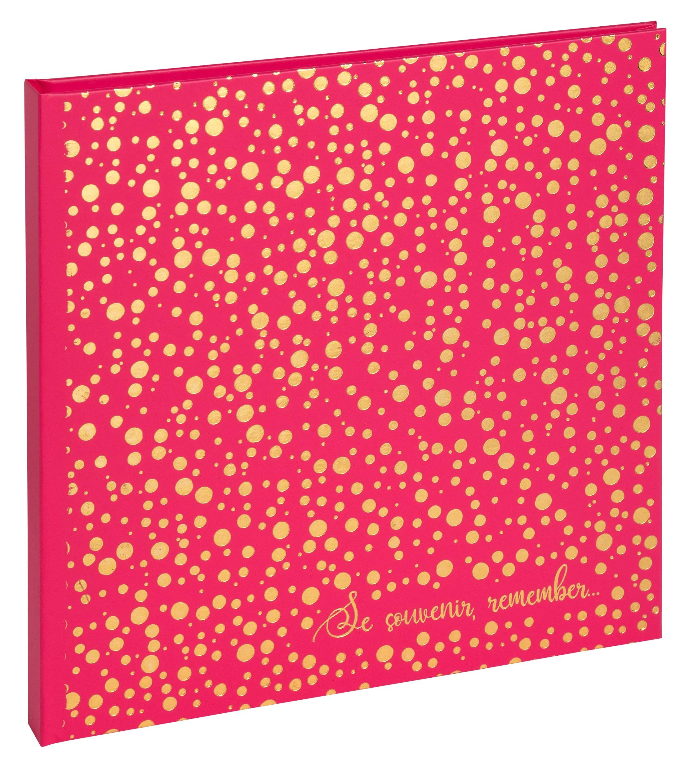 Un cuaderno rosa con puntos dorados y la inscripción "Se souvenir, remember...".
