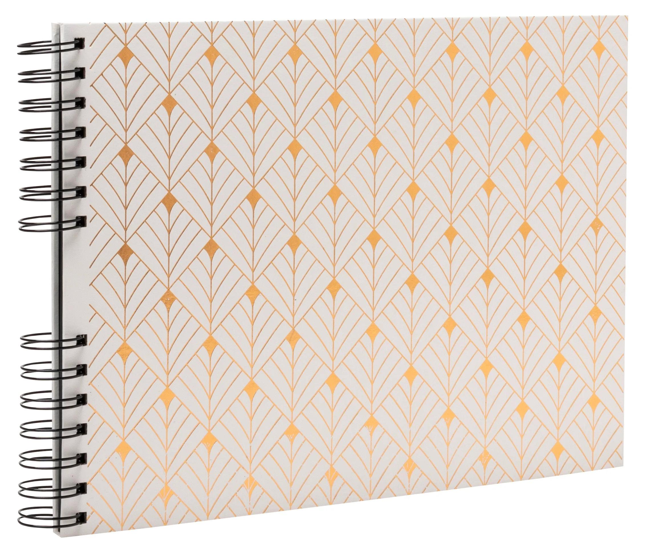 Un cuaderno con tapa blanca y un patrón geométrico dorado.
