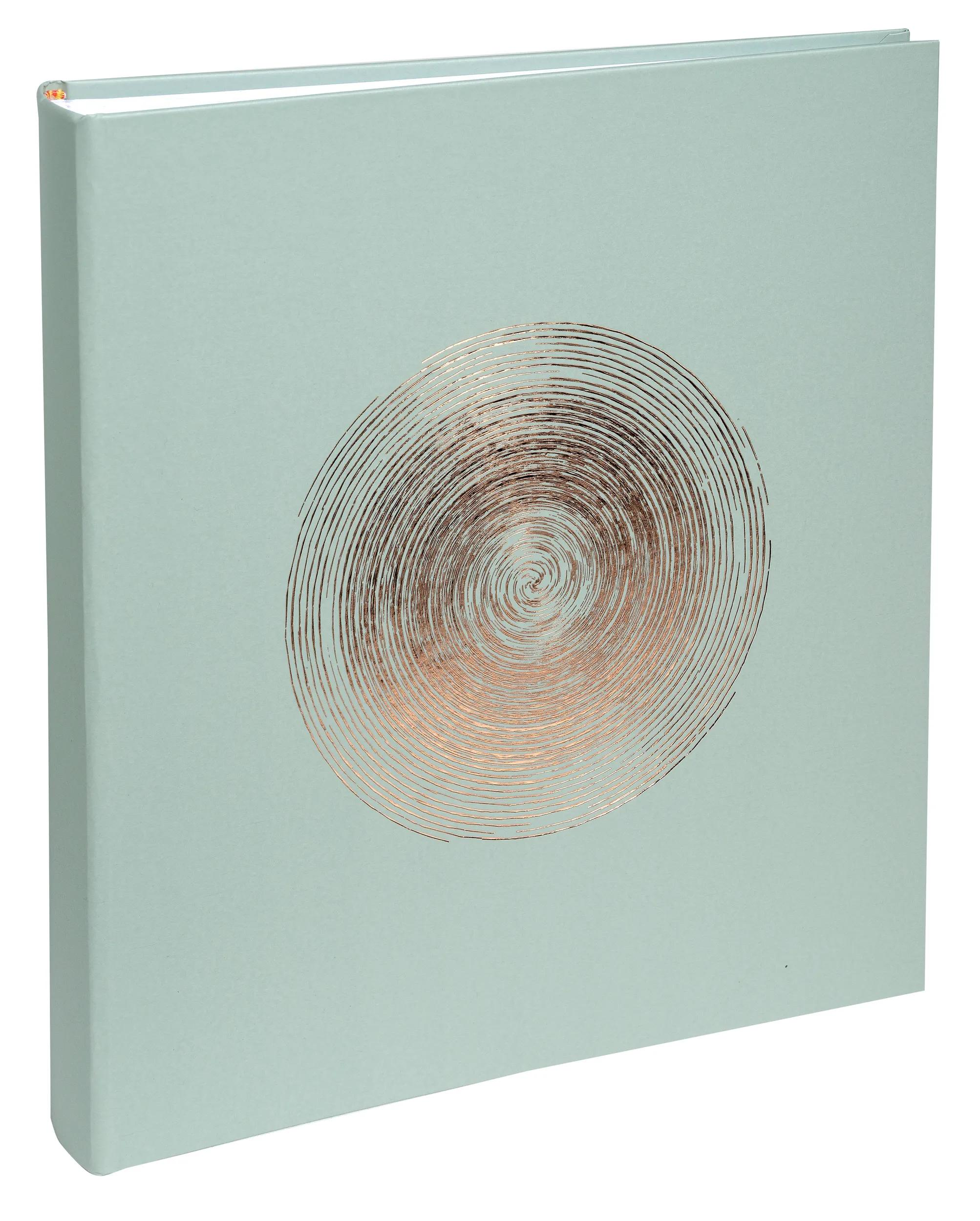 Un libro verde chiaro con un motivo a spirale color rame sulla copertina.