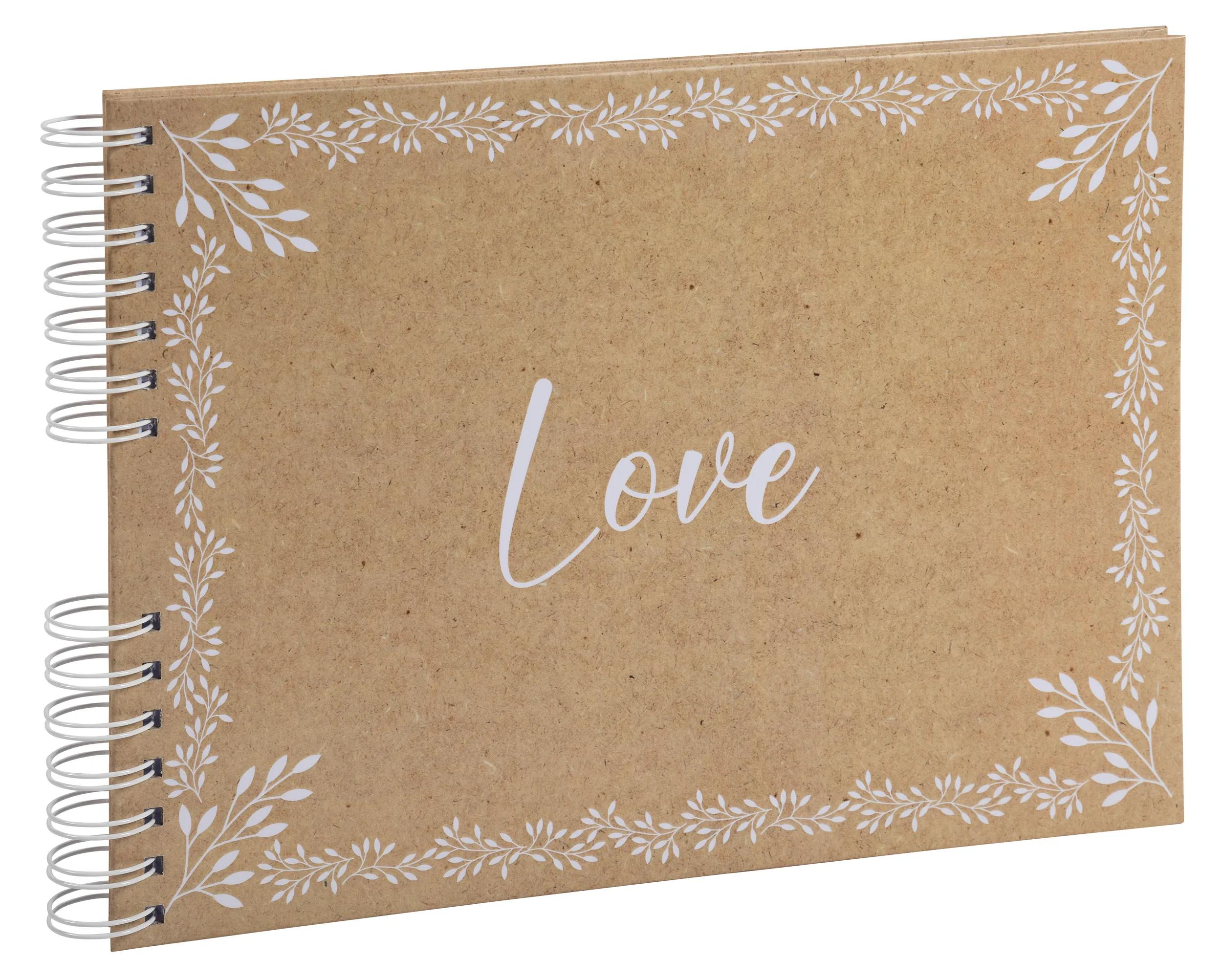 Un cuaderno marrón con diseños de hojas blancas y la palabra "Love" escrita en la portada.